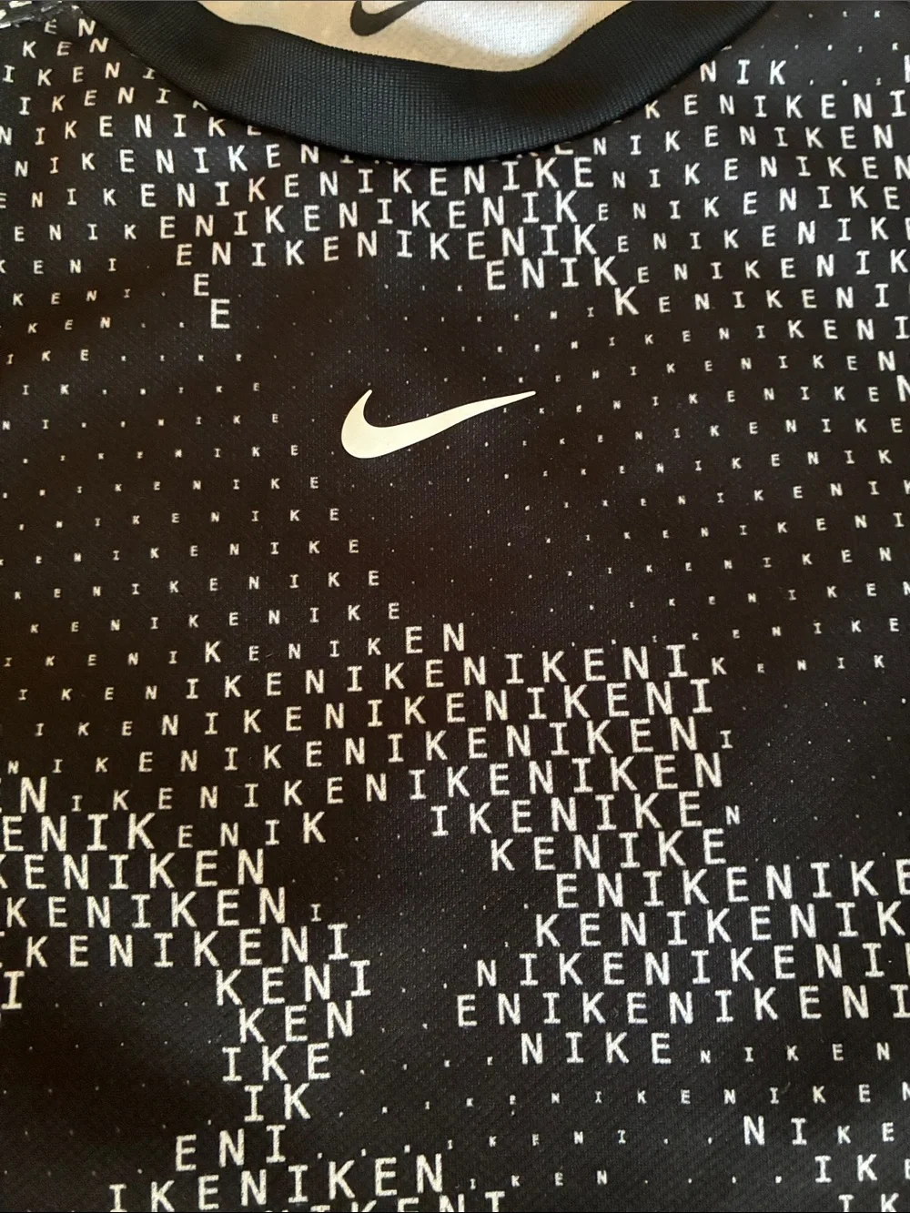 Nike Black Tee with White Micro-Text and Swoosh
